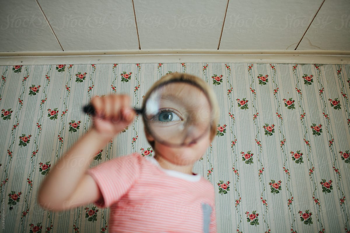 Boy with magnifying glass. by Julia Forsman for Stocksy United