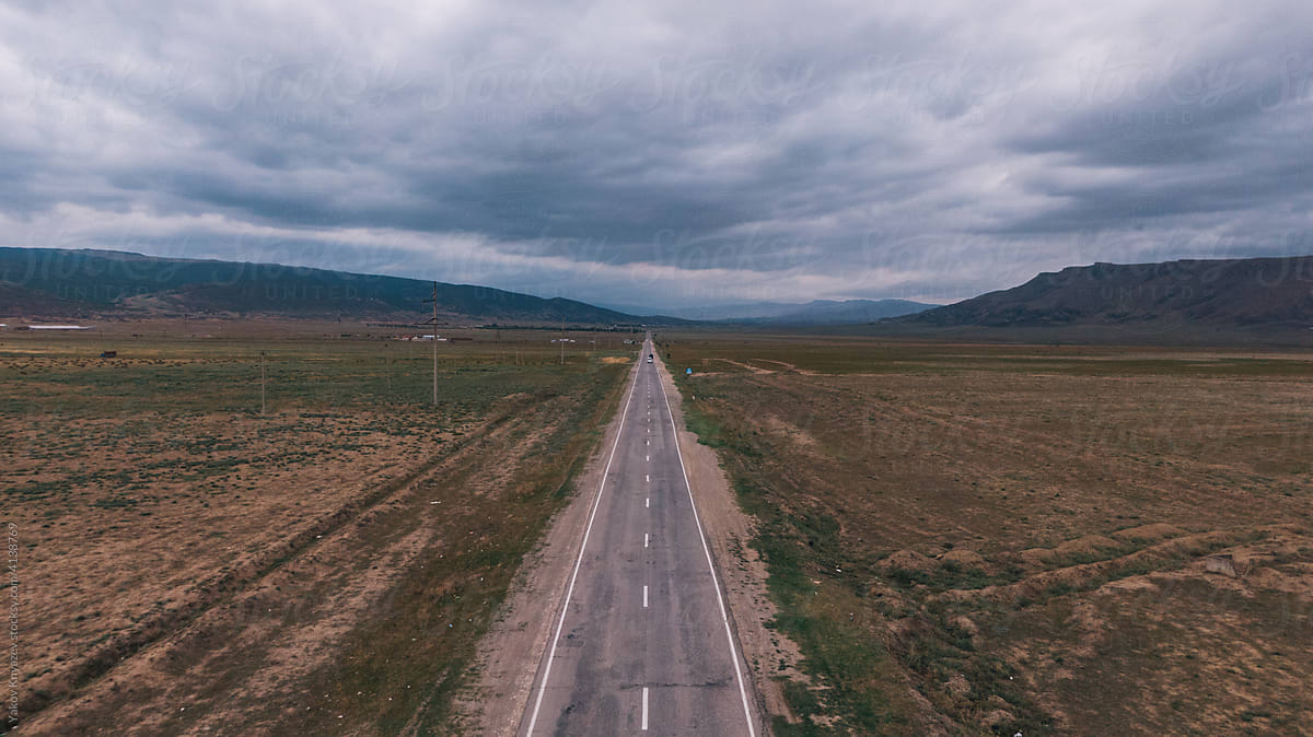 Drone view of a lonely road through the wastelands