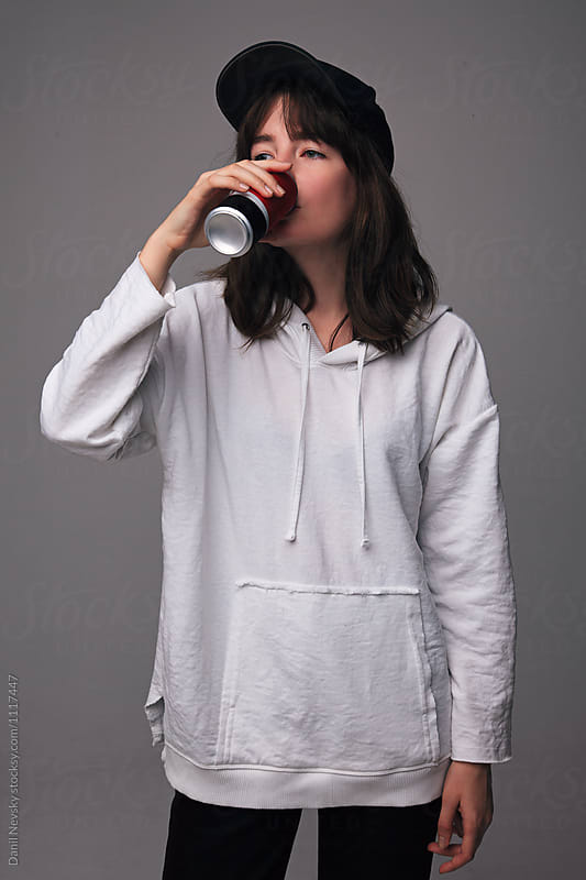 Teen girl drinking soda from can