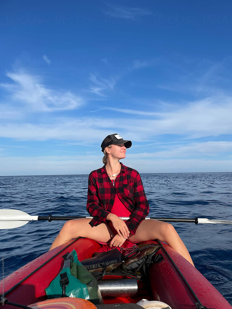 Stylish woman on Kayak on sea