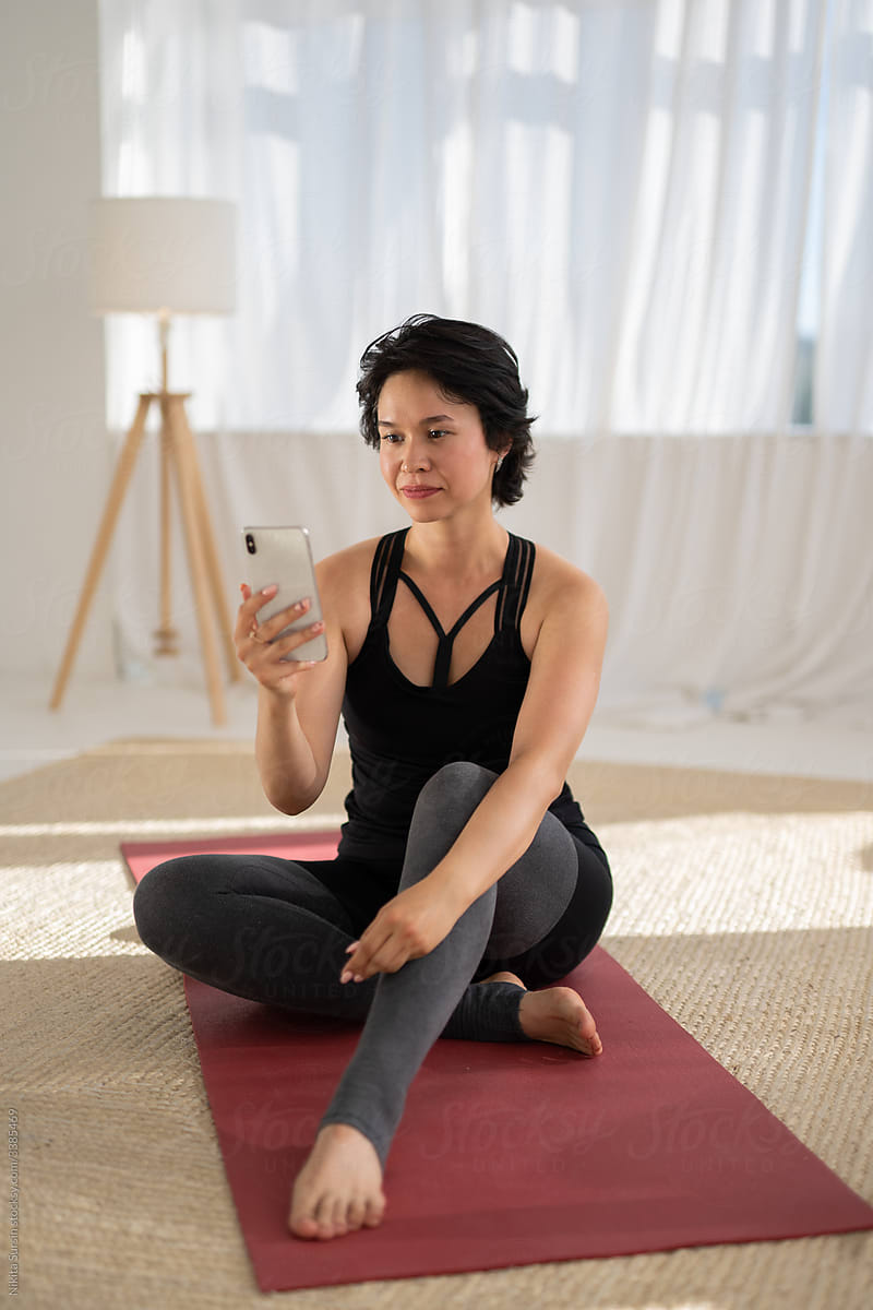 woman using phone after yoga class