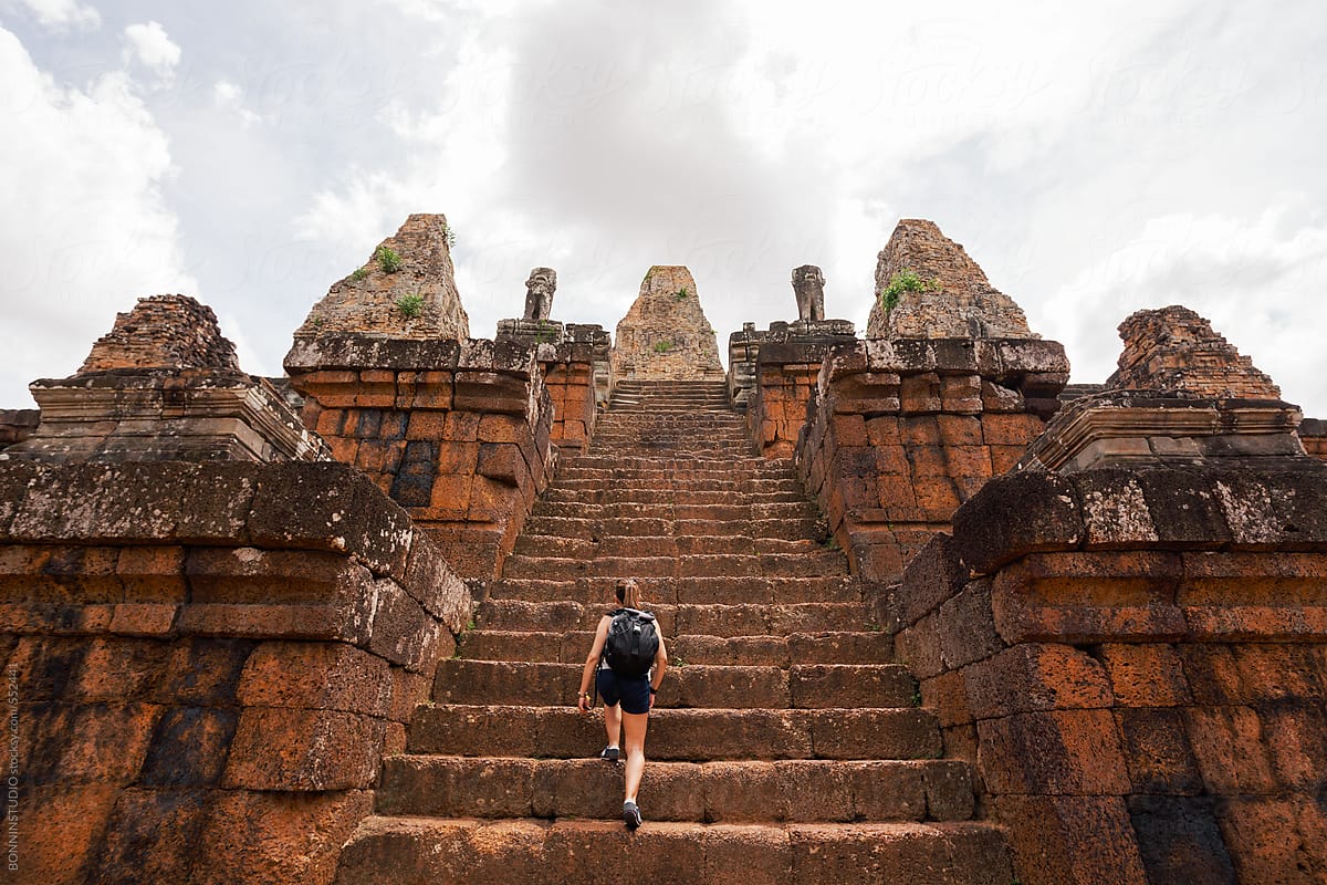 Back view of a female tourist steps on Pre rup temple. Angkor, Cambodia.