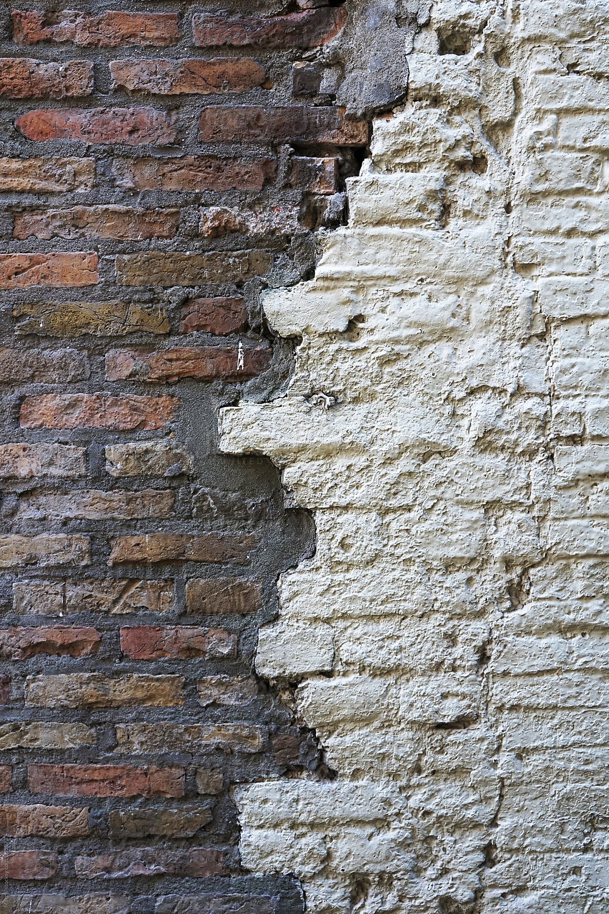 Old brick wall with two different halves meeting