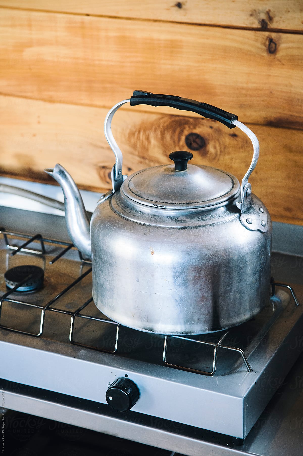 Old fashion kettle on a gas cook top inside a cabin / hut, New Zealand.