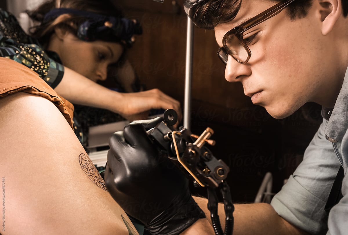 Tattoo session  in retro vintage tattoo studio