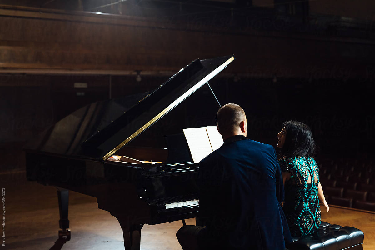 Man and woman, playing a piano