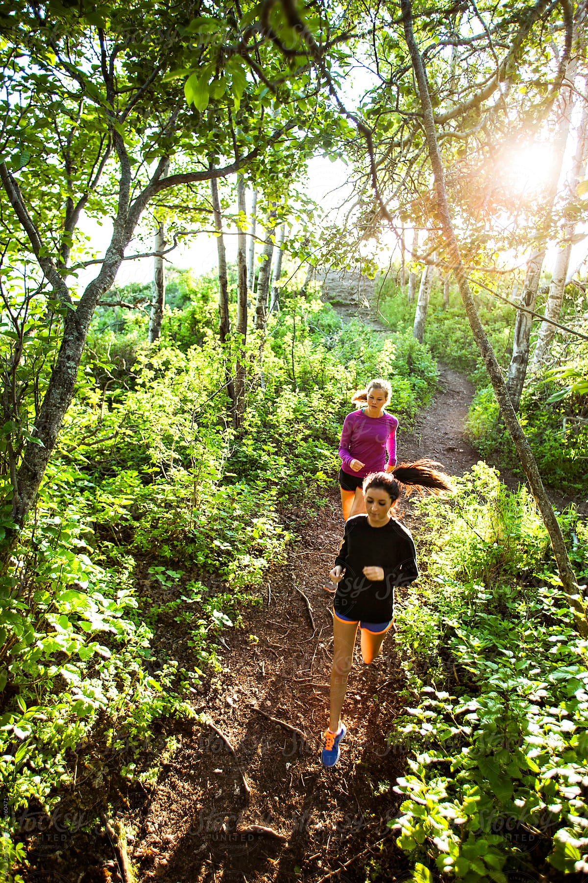 Overhead View of Two Women Running Down a Trail