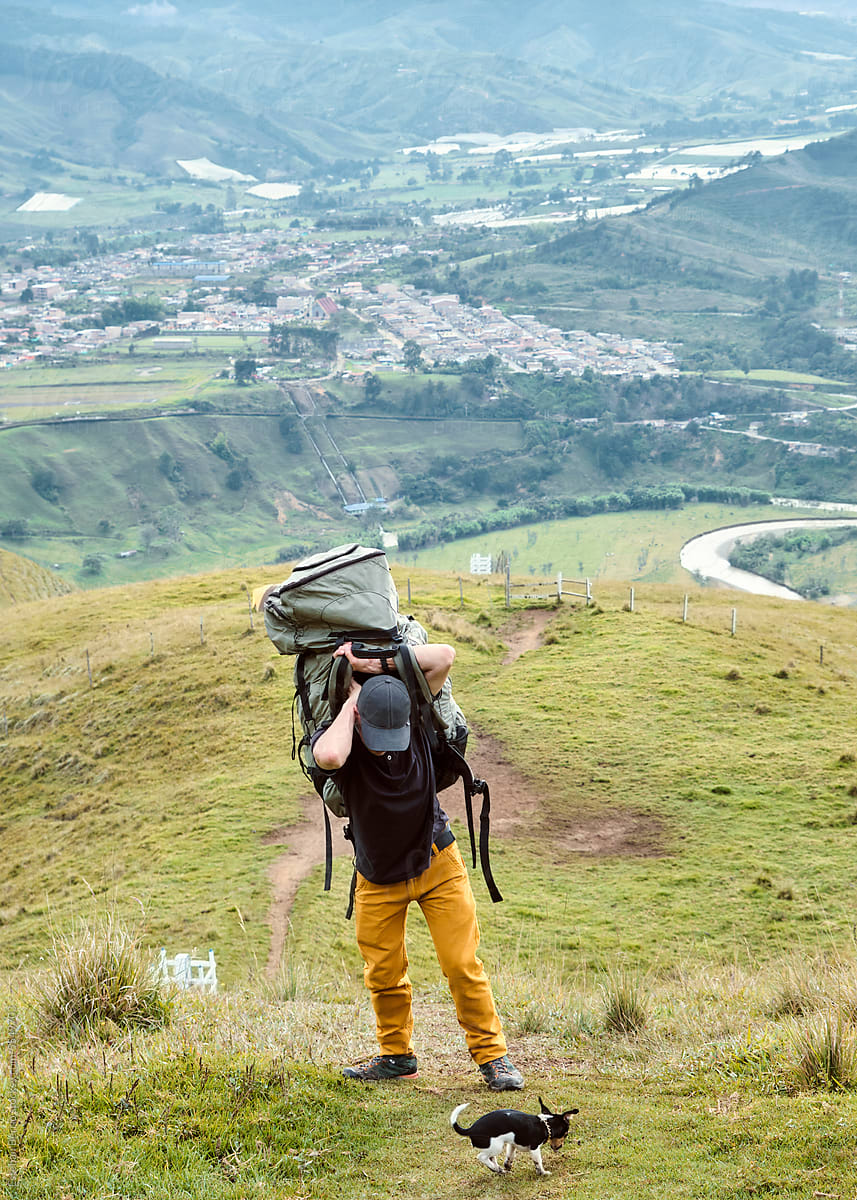 Man carrying a paraglider backpack