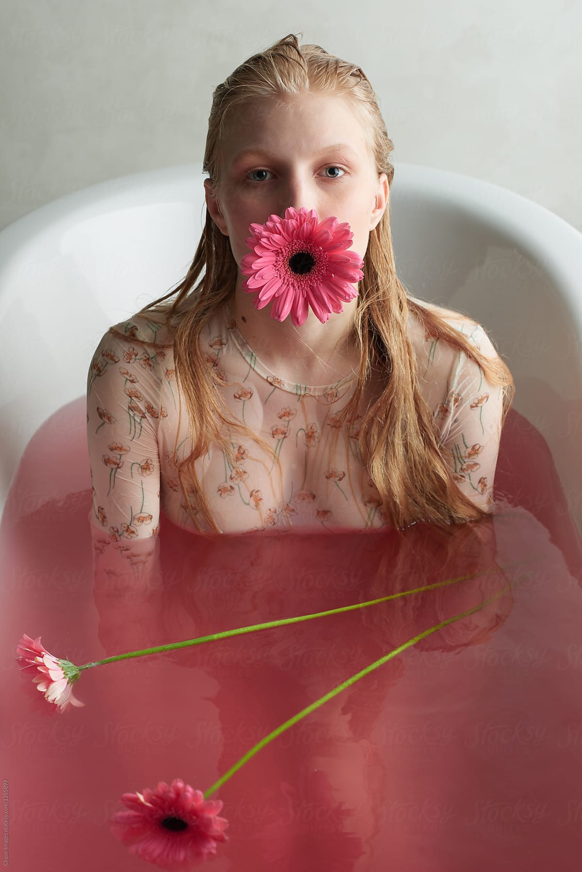 Emotionless girl in pink water