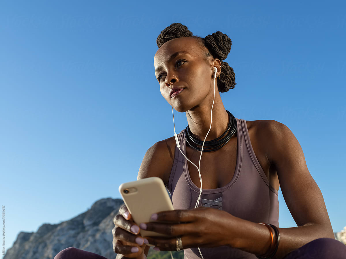 African American jogger listening to music
