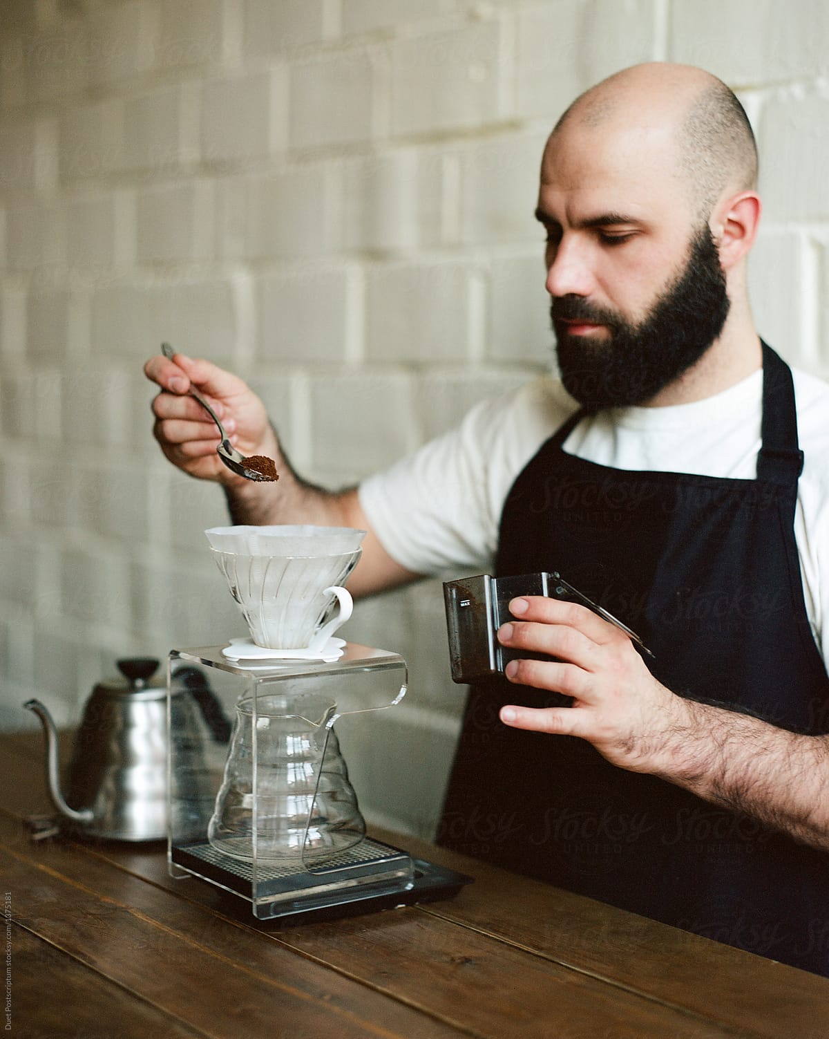 Barista pouring coffee with spoon