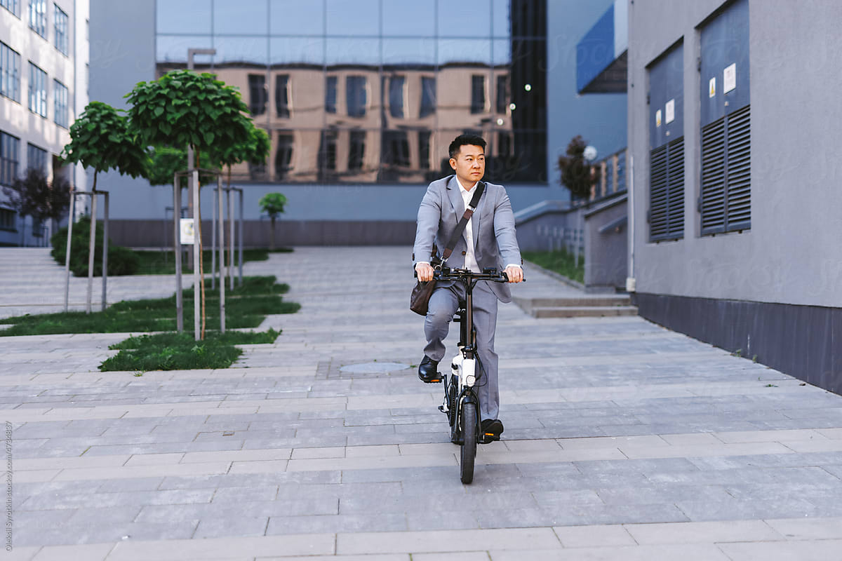 Worker on electric bicycle leaving workplace