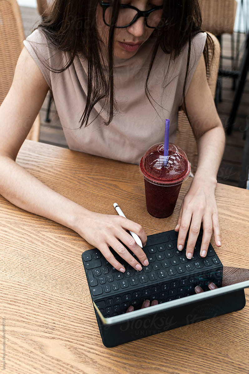 Businesswoman typing on digital tablet