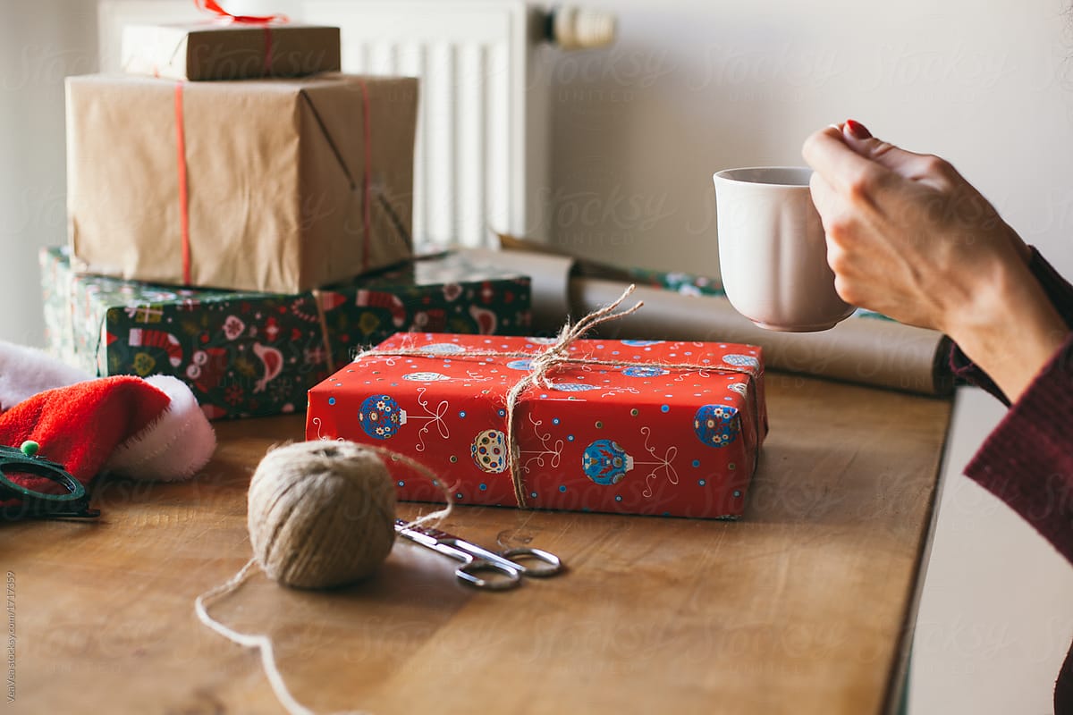 Woman wrapping Christmas presents indoor