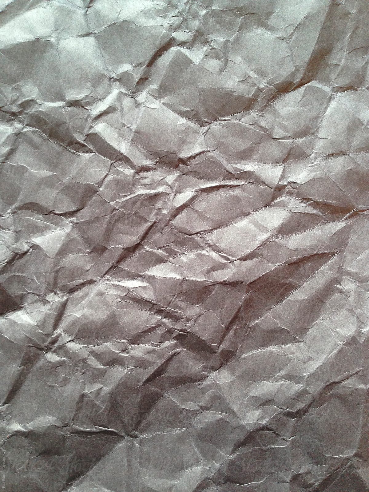 Close Up Of Crumpled Piece Of Construction Paper by Stocksy
