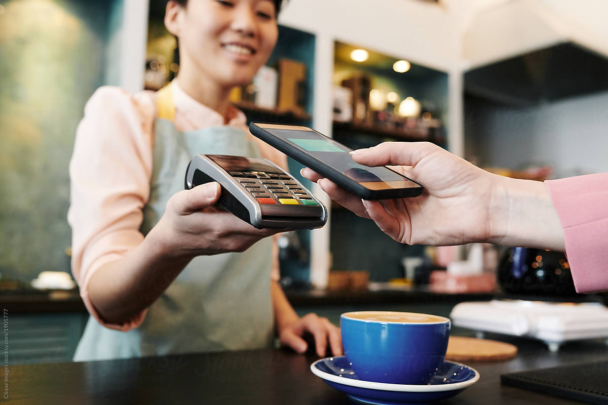 Customer paying for coffee with phone