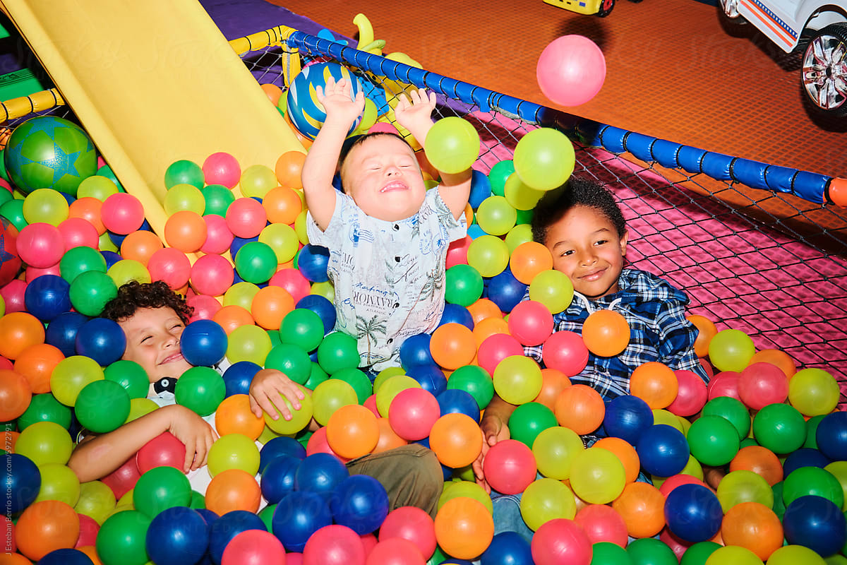 Group of Latino kids playing in a ball pool