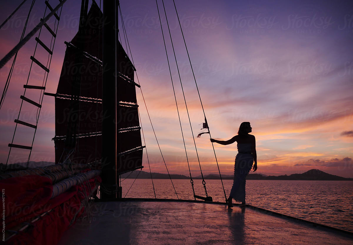 Woman relaxing on a boat at sunset