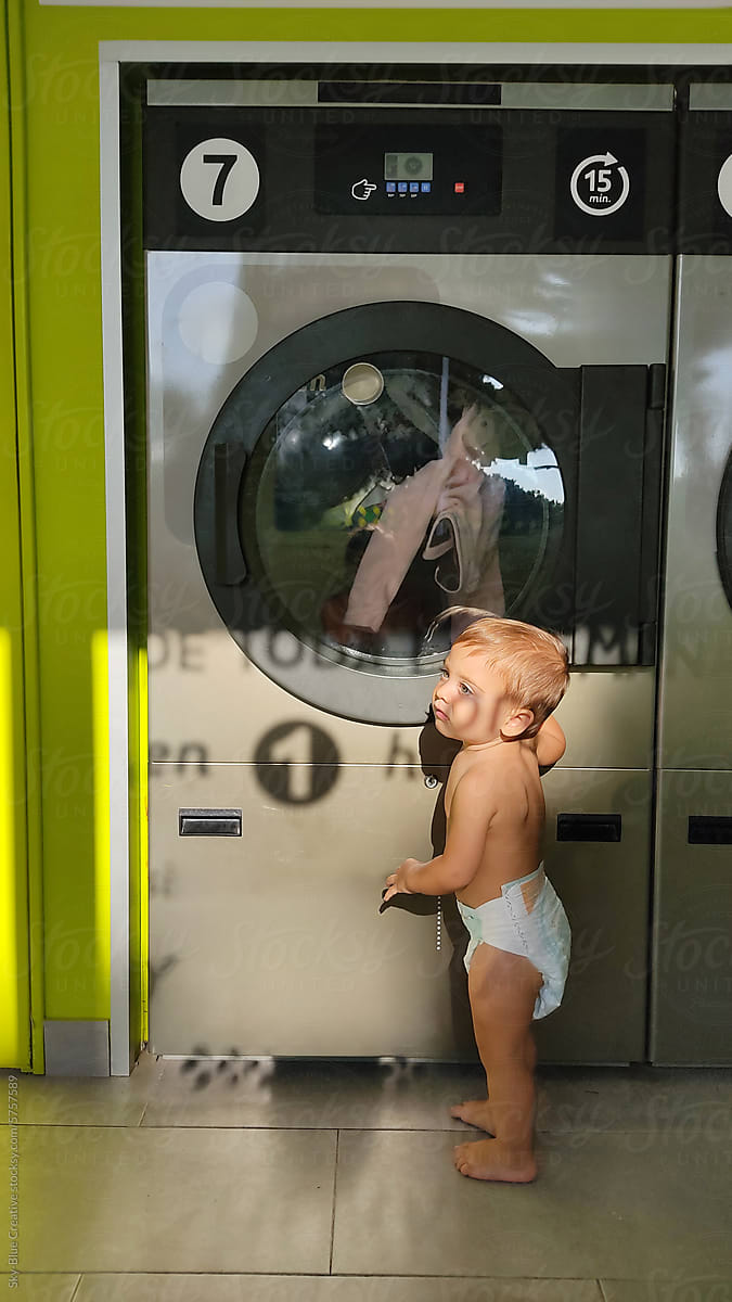 Ugc photo of baby in diaper waiting for washing machine to finish