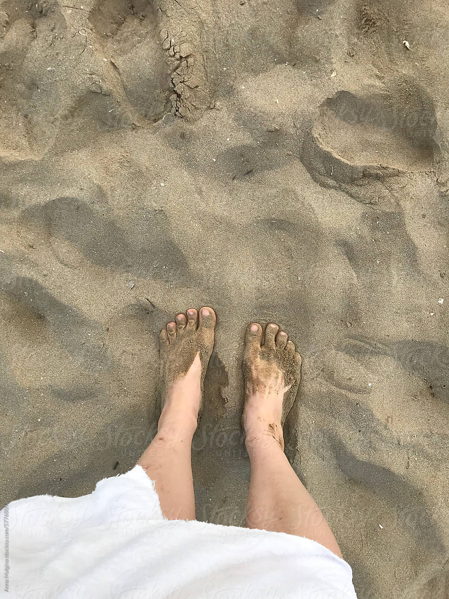 Bare Feet Standing on Sandy Beach