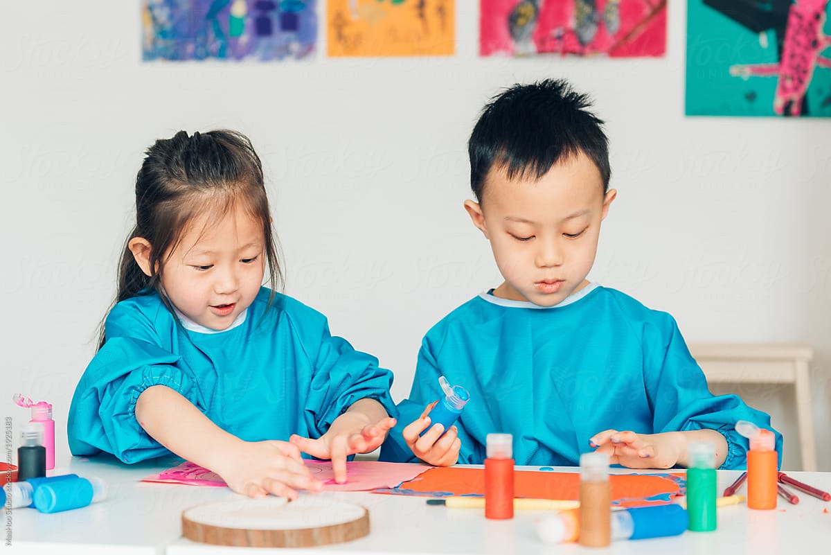 Preschool kids painting in classroom