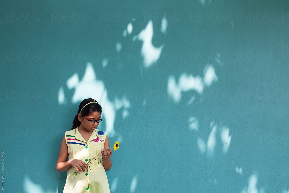 A teenage girl holding sunflower