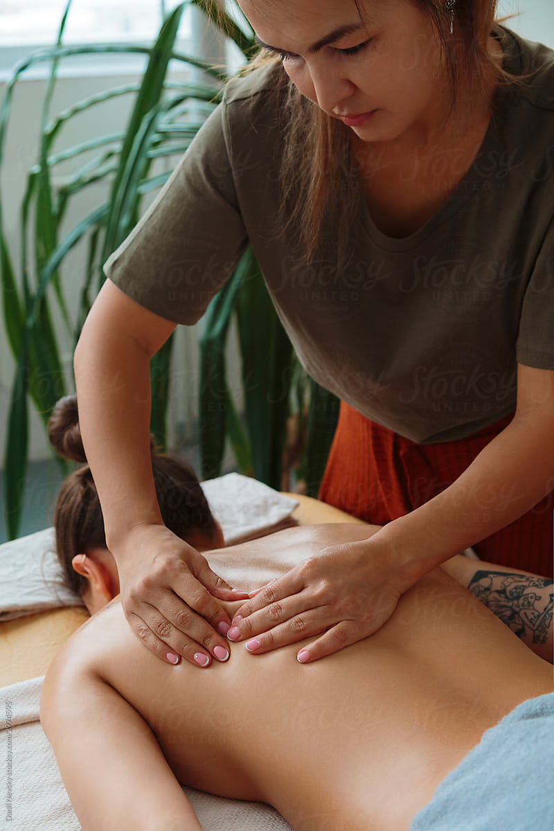 Woman receiving professional back massage