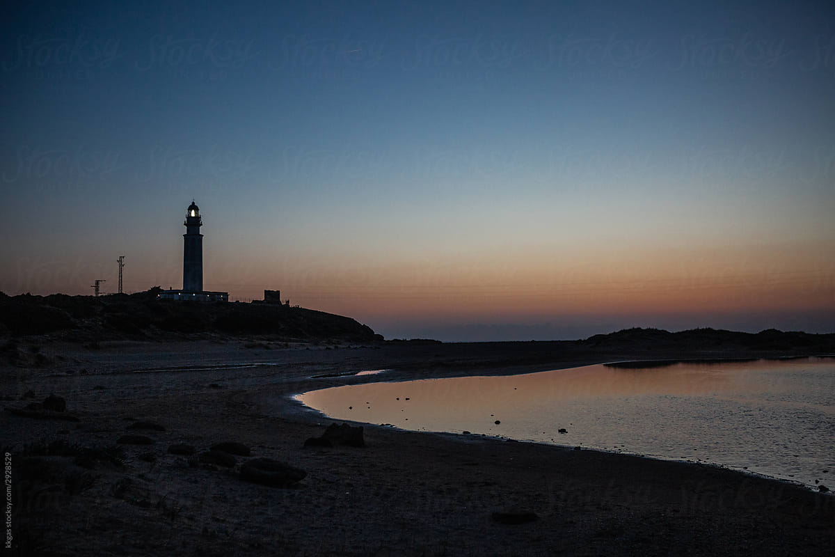 Lighthouse and beach at dusk