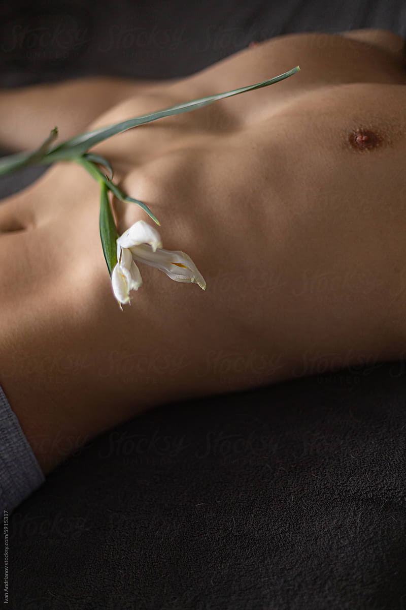 Naked Man Lies Relaxed With Delicate Flower