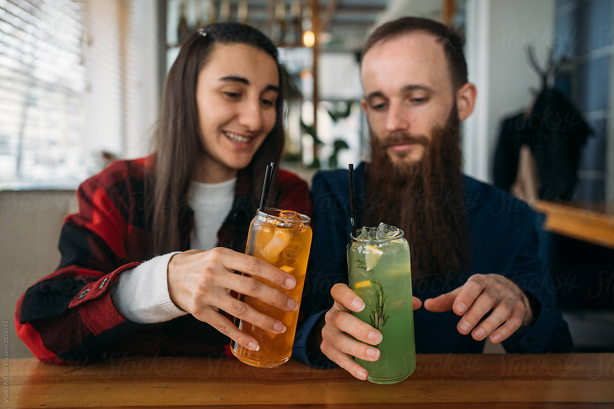 Couple drinking cocktails in cafe