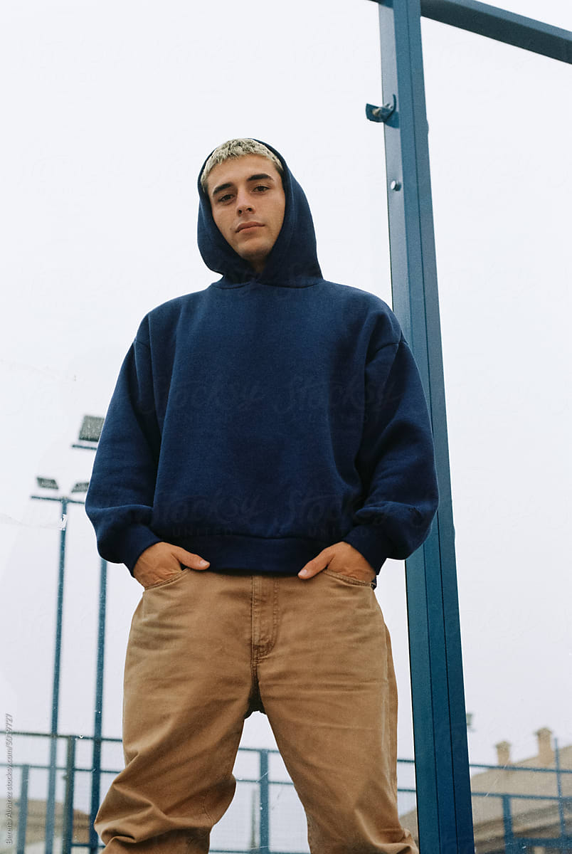 portrait of young man in blue hoodie