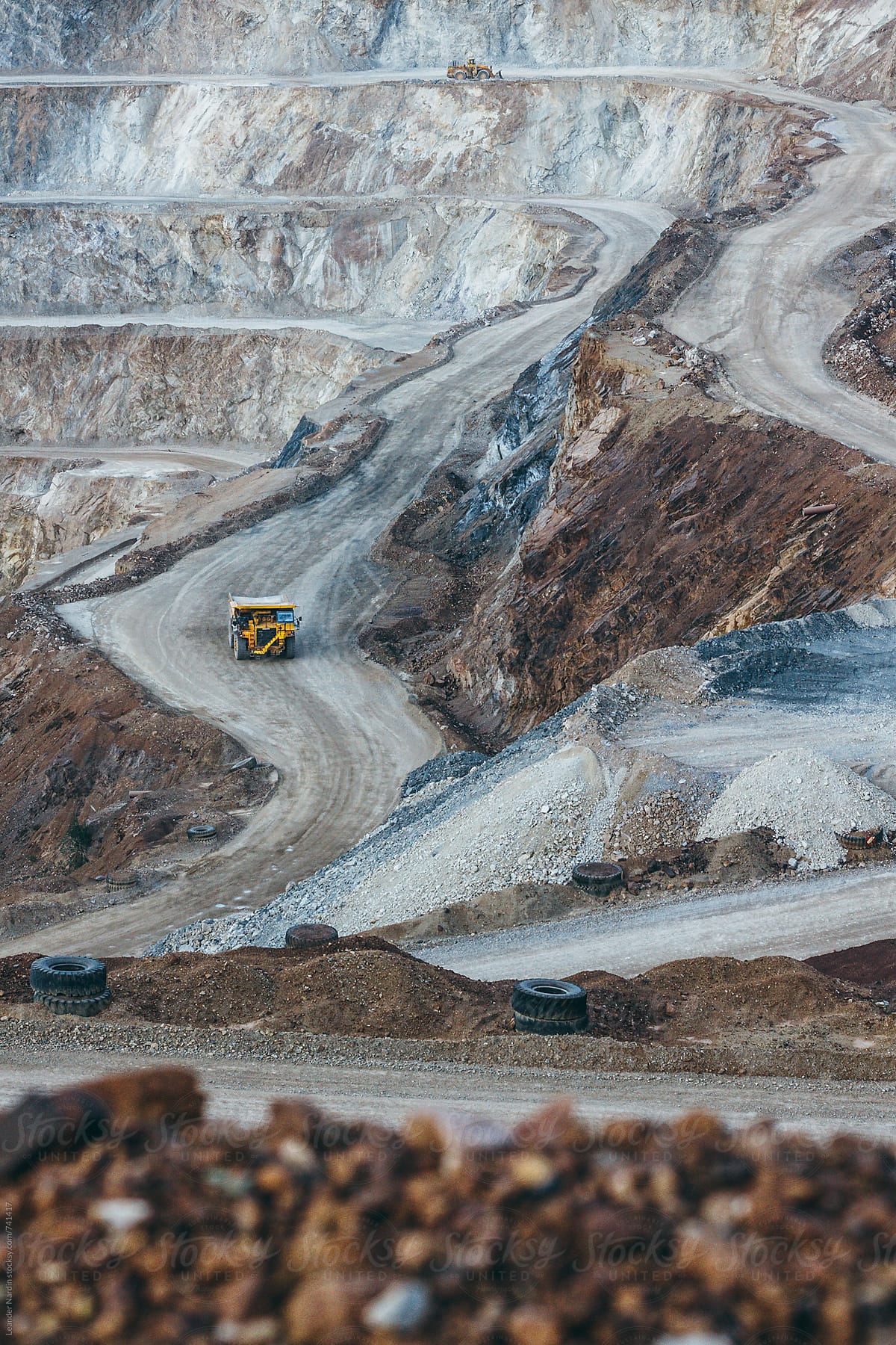 yellow quarry truck in strip mining area