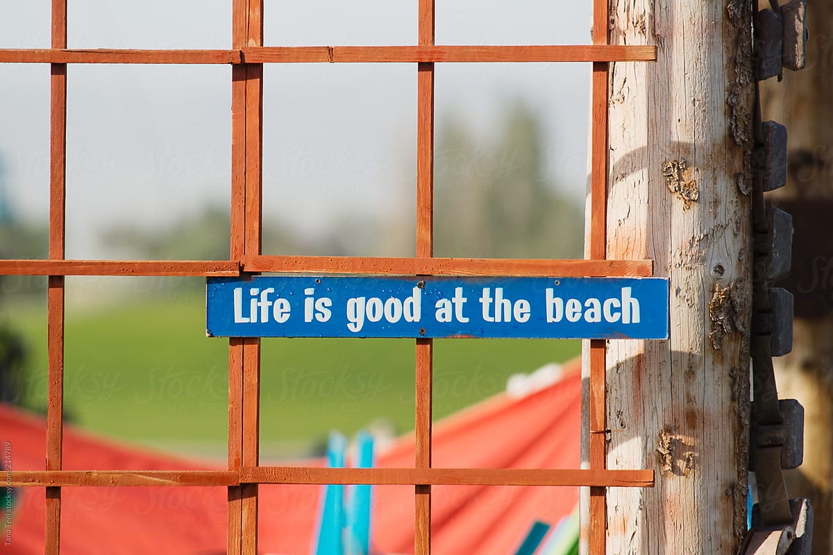 A sign located on outside of porch area at the beach
