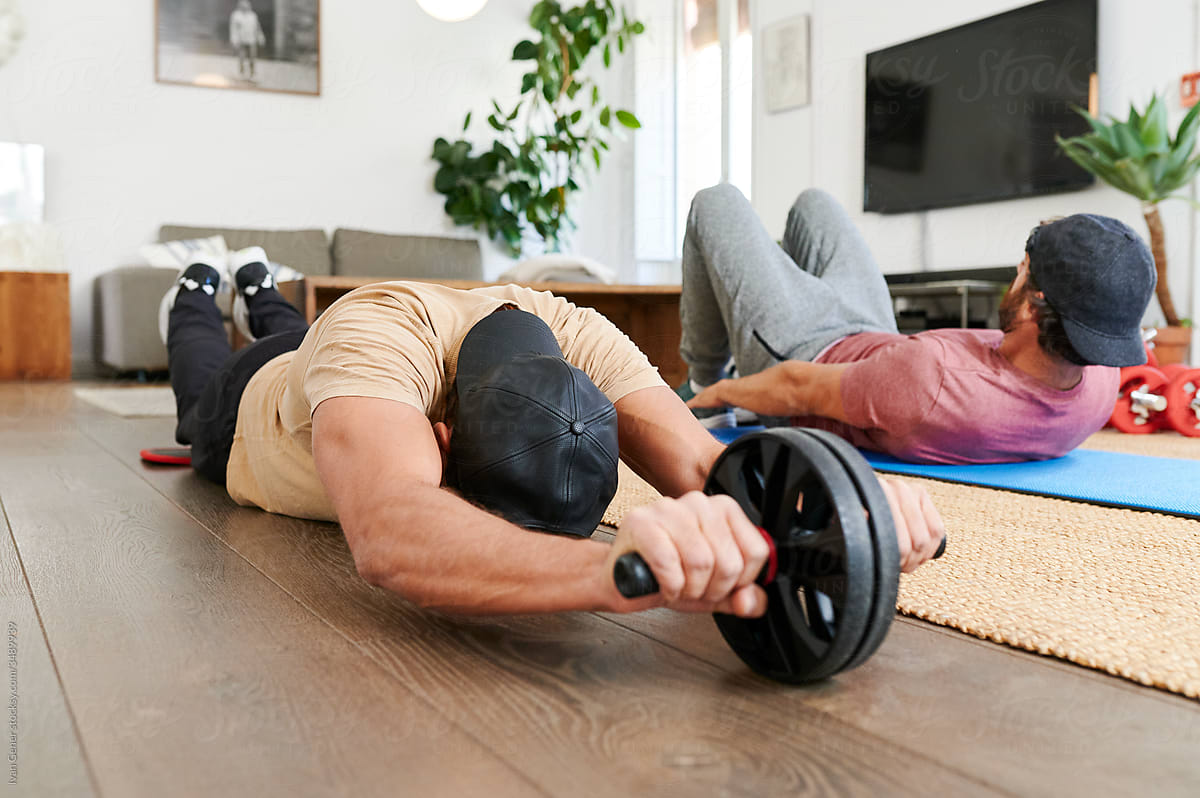 Two fit men working out at home