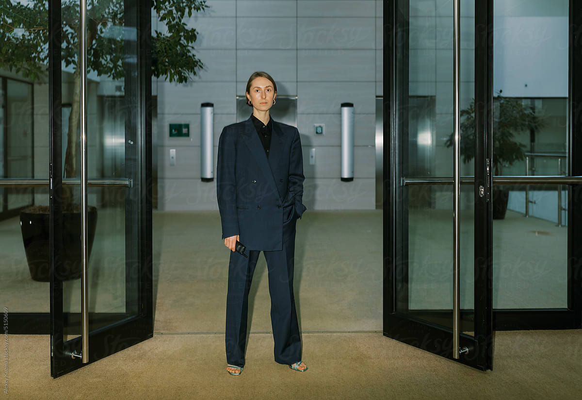 Androgyne woman wearing man classic suite  indoors