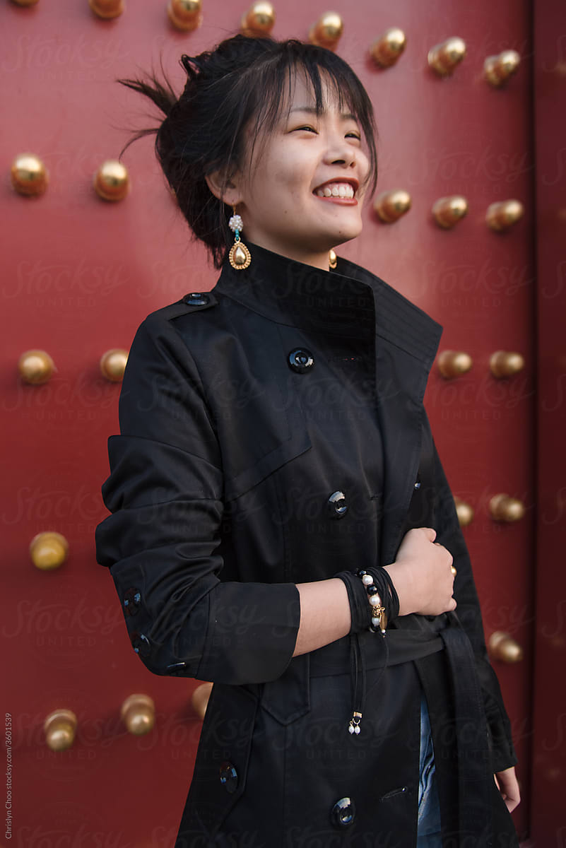 Smiling woman wearing modern trench coat