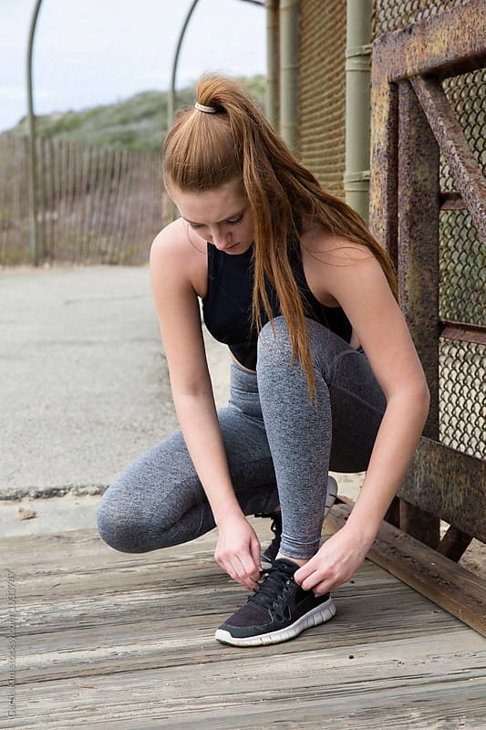 Young athletic woman tying shoelace