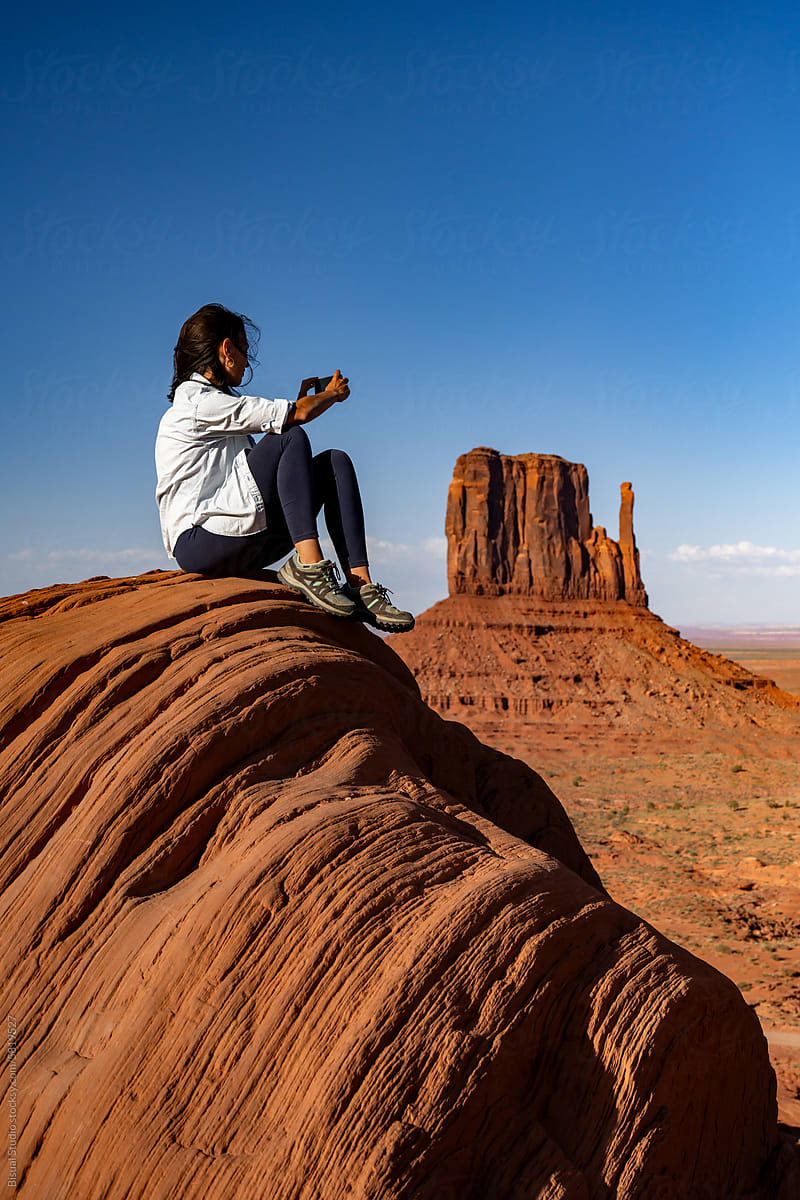 Woman taking a photo of Monument Valley
