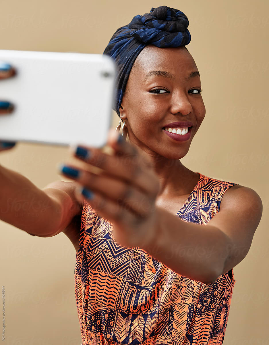 Young black woman taking a selfie.