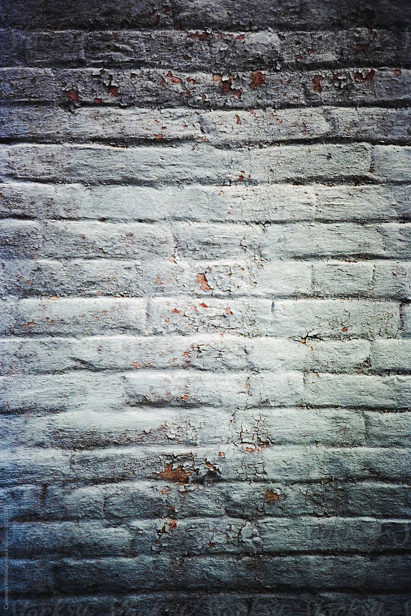 White brick wall with peeling paint