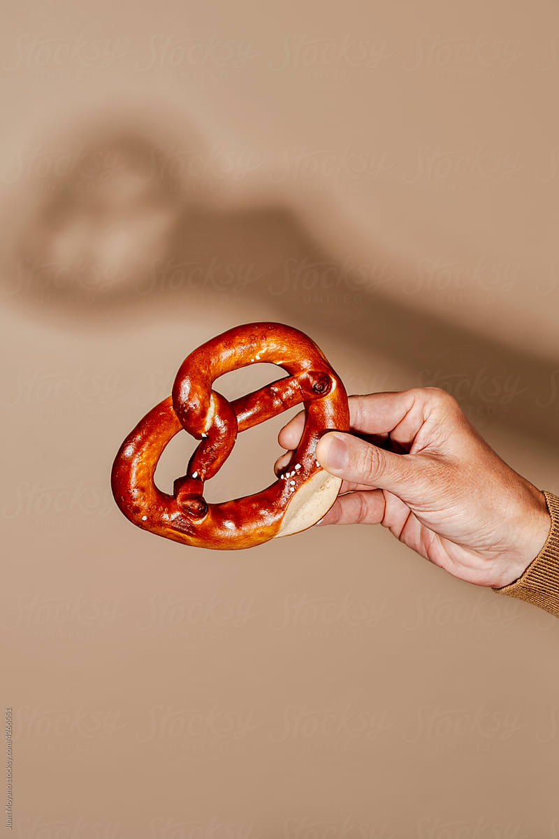 man with a smiley pretzel in his hand