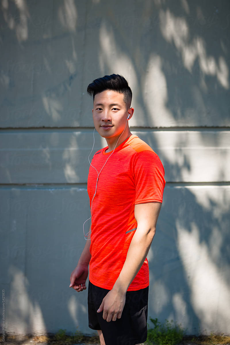 Asian Athlete Portrait on Concrete Wall Outdoors