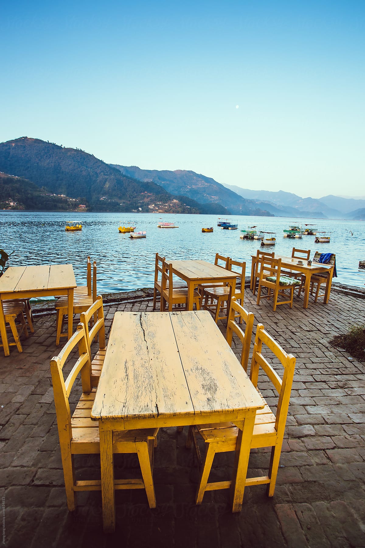 Tables and chairs beside the Phewa lake in Pokhara,Nepal