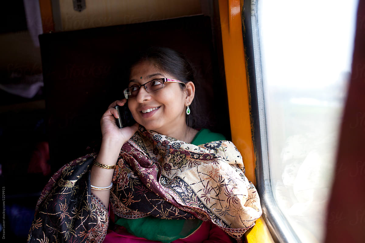 Indian Woman Talking And Laughing Using Smartphone By Stocksy Contributor Dream Lover Stocksy 