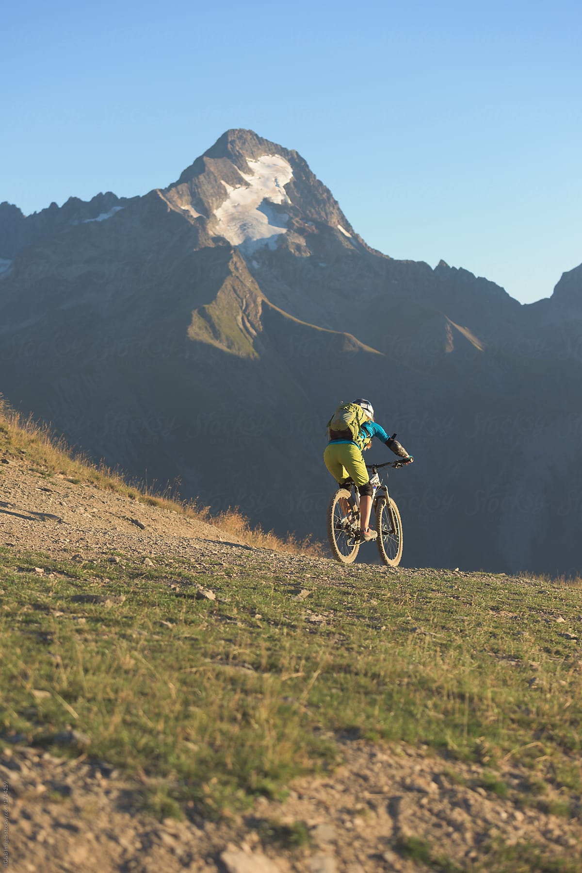 Mountain biker riding alone on backcountry route in the Alps