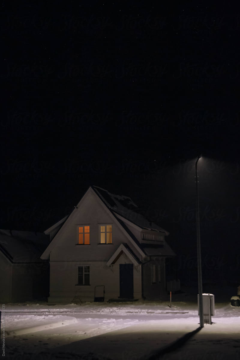 House and streetlamp at night