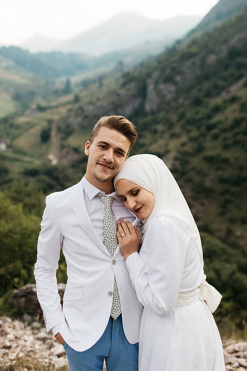 Happy couple standing and hugging in the mountains