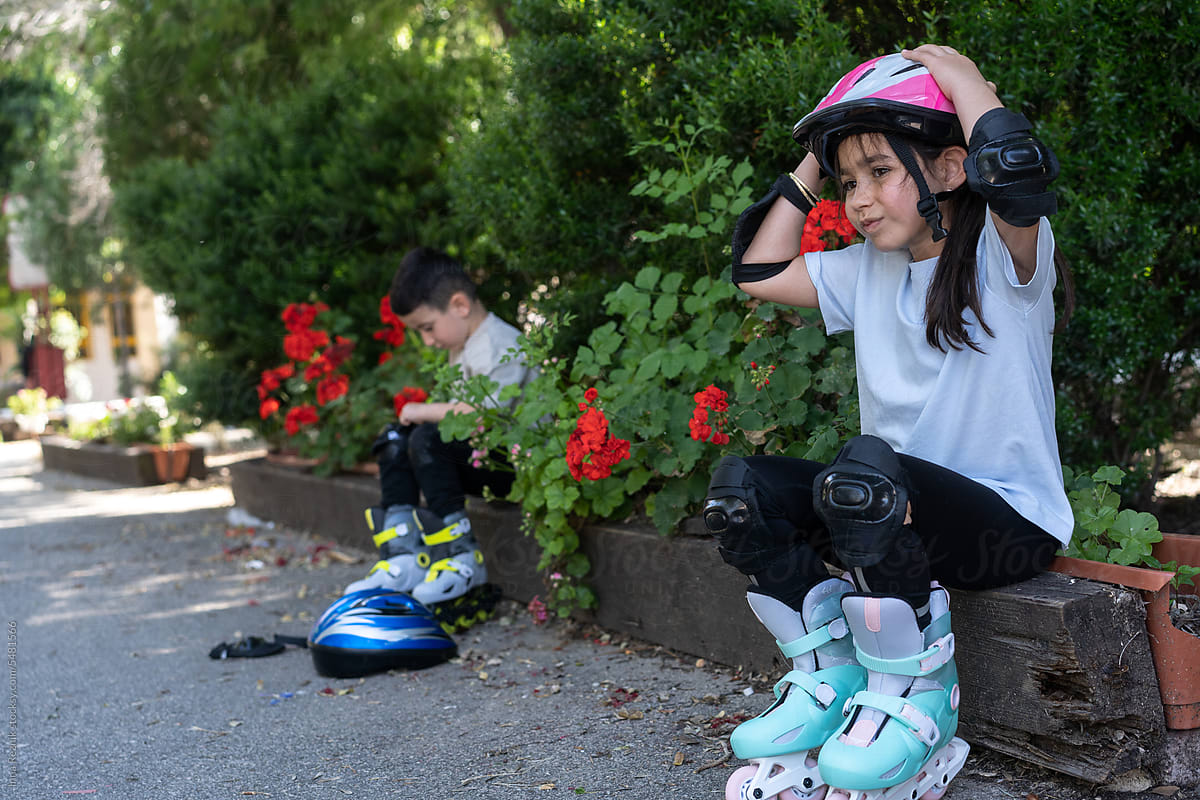 Milestone Moment Girl and Boy Prepare for First Roller Skating Session