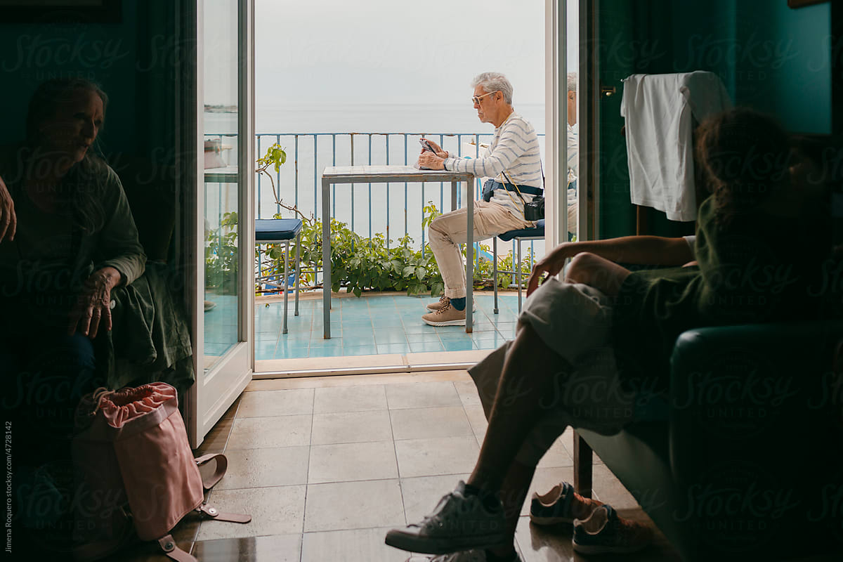 Family in hotel room with balcony