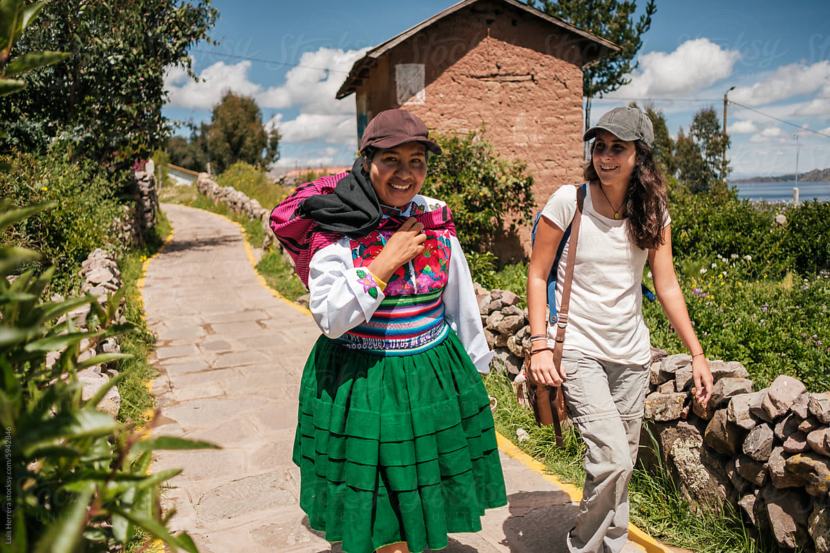 indigenous woman walking with tourist. local tourism